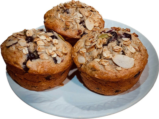Three Granolala topped Blueberry Banana muffins on round plate